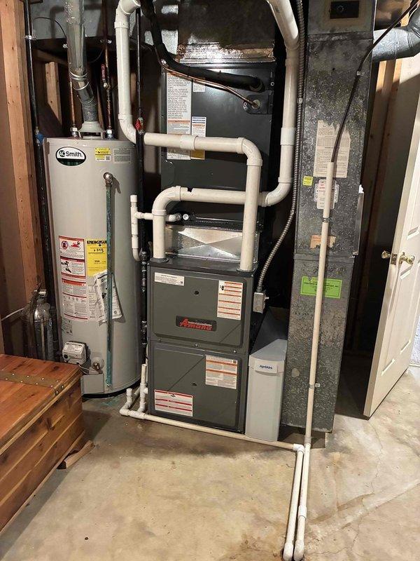 Successfully installed an Amana furnace unit in the basement utility room, including proper connection to existing A.O. Smith water heater and ductwork. All PVC ventilation piping and drainage systems were professionally routed and secured, with final system testing confirming proper operation of the new heating system.