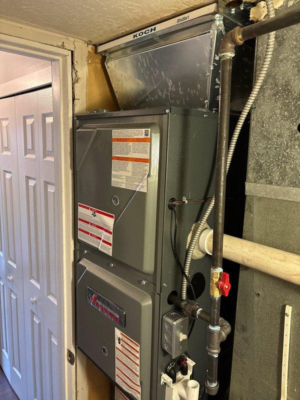 Successfully installed a 96% efficiency Koch furnace and AC system in the utility closet. System includes properly connected PVC ventilation pipes, copper line set with appropriate valves, and all required safety labels. Unit placement allows for adequate service access and the installation area was left clean and organized.