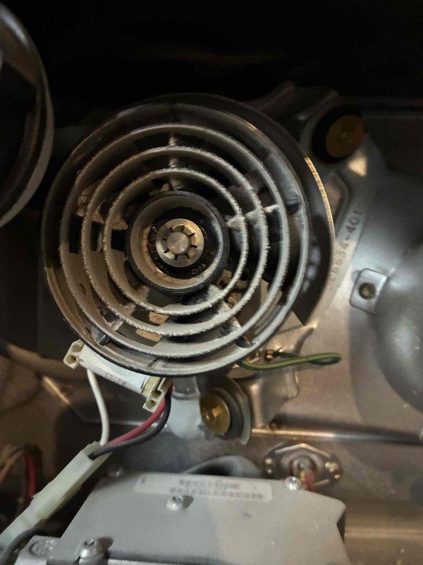 Responded to service call for furnace producing metal grinding noise. Inspection revealed significant dust accumulation on the blower wheel assembly and housing. Cleaned blower wheel fins and surrounding components to restore proper operation and eliminate noise.