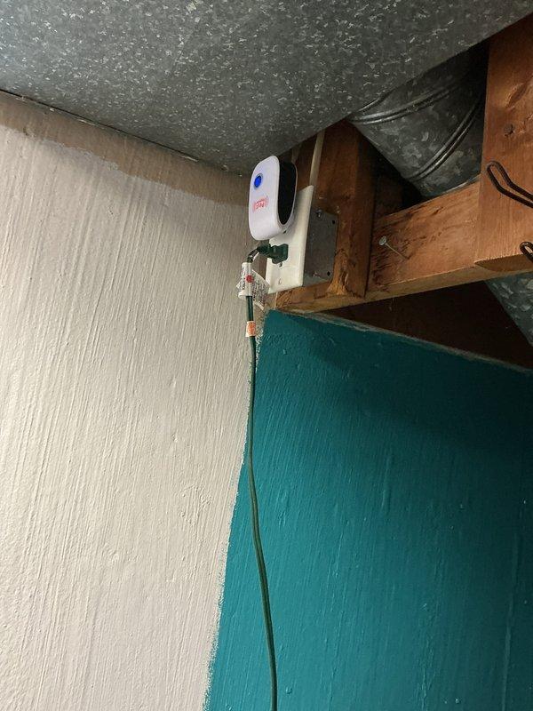 Conducted electrical inspection of circuit breaker panel, confirming proper installation of Square D breakers with no visible damage or abnormal wear. Examined wall-mounted electrical outlet with indicator light and inspected surrounding structural elements including wooden support beams and ceiling components.
