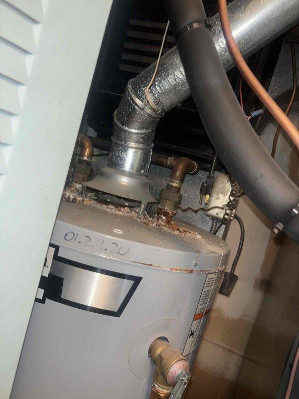 Completed scheduled heating maintenance service on furnace system. Observed water heater with accumulated dust on top and identified deteriorated rubber gasket with visible cracking that requires replacement. System was inspected and serviced according to manufacturer specifications.