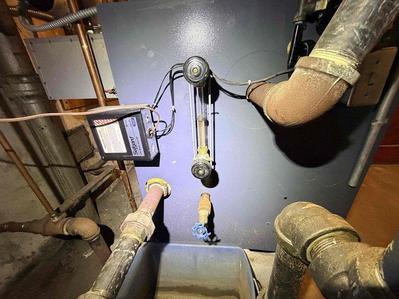 Responded to no-heat call for residential boiler system. Upon inspection, identified faulty pressure regulator valve and air in system as root causes. Bled air from system, replaced pressure regulator, and restored proper system pressure, successfully restoring heat functionality.