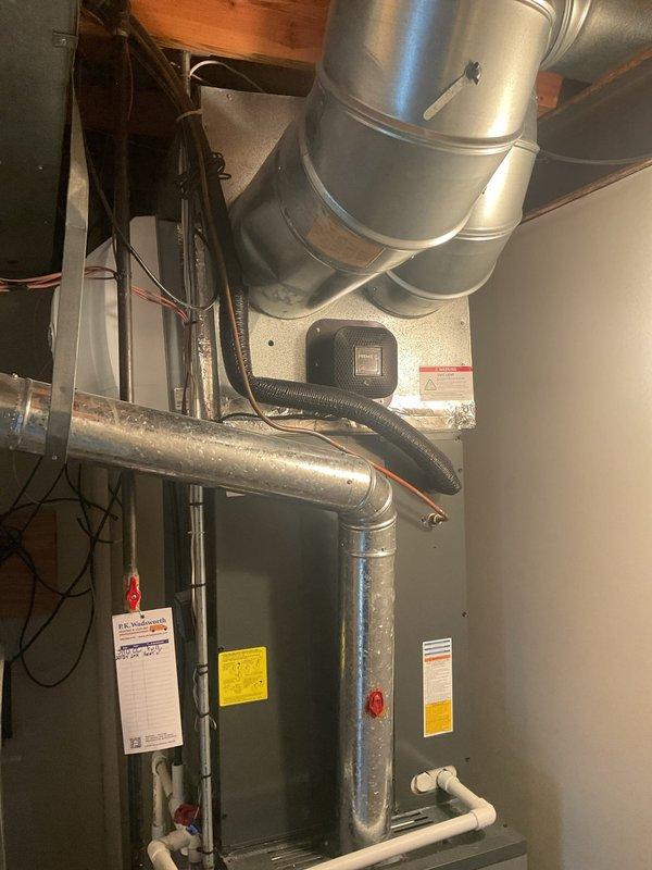 Completed routine heating system tune-up on residential furnace system. Inspected and serviced the main furnace unit, associated PVC ventilation/drainage pipes, and connected ductwork. All components were found to be in proper working order with no issues identified.