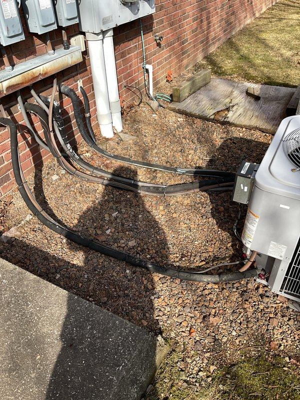 Conducted site assessment of four outdoor heat pump/AC units and associated electrical service connections for potential commercial maintenance agreement. Documented current installation configuration including multiple conduit lines, service panels, and exterior unit placement. Customer expressed interest in establishing regular maintenance service for the commercial HVAC system.
