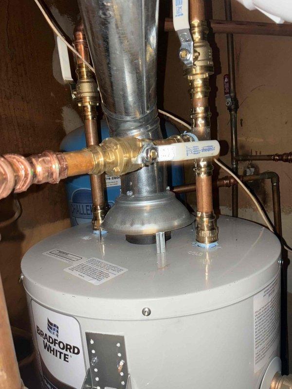 Responded to service call regarding hot water flowing into toilet. Diagnosed cross-connection issue between newly installed Bradford White water heater (installed on 3/2/26) and toilet supply line. Corrected improper pipe connections at water heater manifold, eliminating thermal mixing problem and restoring proper cold water flow to toilet fixture.