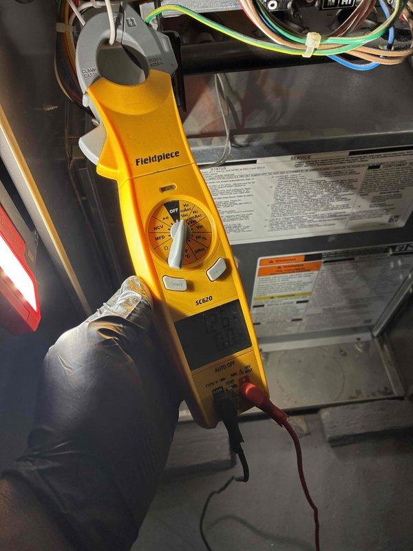 Performed scheduled heating maintenance on furnace system. Conducted electrical diagnostics using clamp meter to verify proper voltage/amperage readings on control circuits and components. Measured supply air temperature (64.0°F) with digital thermometer to confirm system operation within manufacturer specifications.