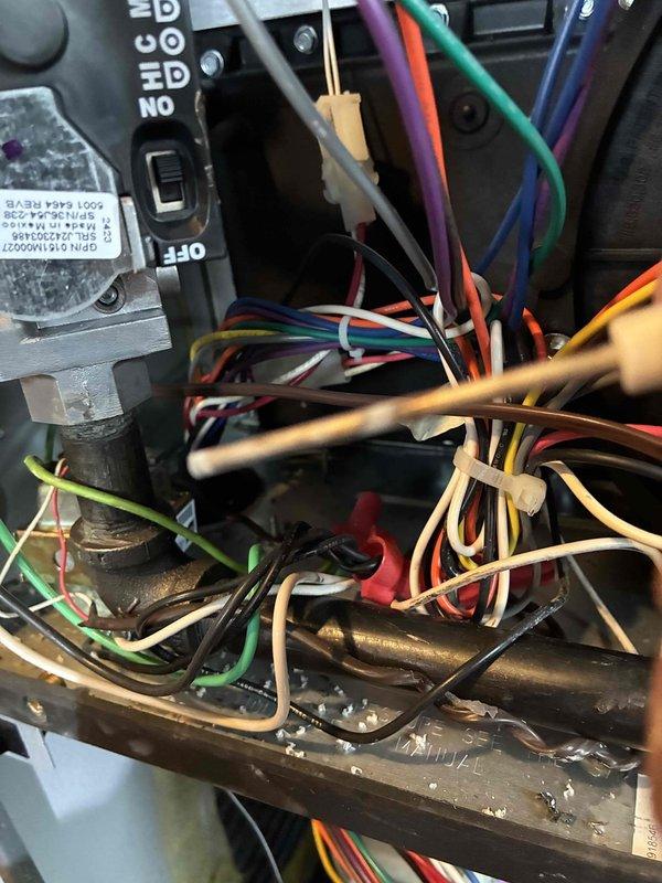 Conducted scheduled heating maintenance service on furnace system. Inspected control board wiring connections and verified proper wire routing/securing with zip ties. Examined junction box installation and confirmed integrity of flexible metal conduit and refrigerant line positioning.