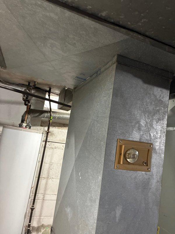 Performed inspection of damaged HVAC system affected by weather-related issues. Documented extensive water damage and discoloration on concrete block walls in utility area where electrical panel and HVAC components are installed. Observed possible mold/mildew growth indicating ongoing moisture problems that have compromised the air handler and associated ductwork. Provided replacement options for the weather-damaged AC system.