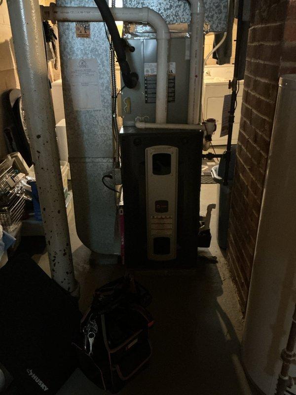 Performed scheduled maintenance on residential heating system. Inspected furnace unit with connected ductwork and PVC venting, ensuring proper operation. Also examined adjacent water heater with exhaust system and associated mechanical components, confirming all systems are functioning within normal parameters.