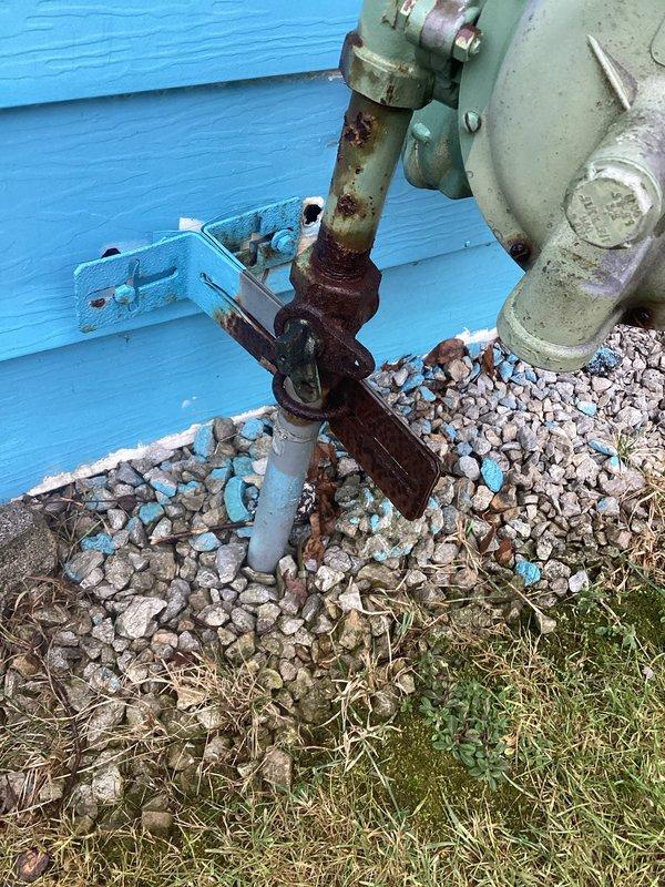 Responded to service call for a small gas leak in pipe running from near garage through the garage. Inspected outdoor gas meter which showed significant corrosion and rust at valve assembly and pipe joints. Further examination revealed deteriorated metal union connector on vertical pipe in utility space with visible threading issues and signs of previous maintenance attempts.