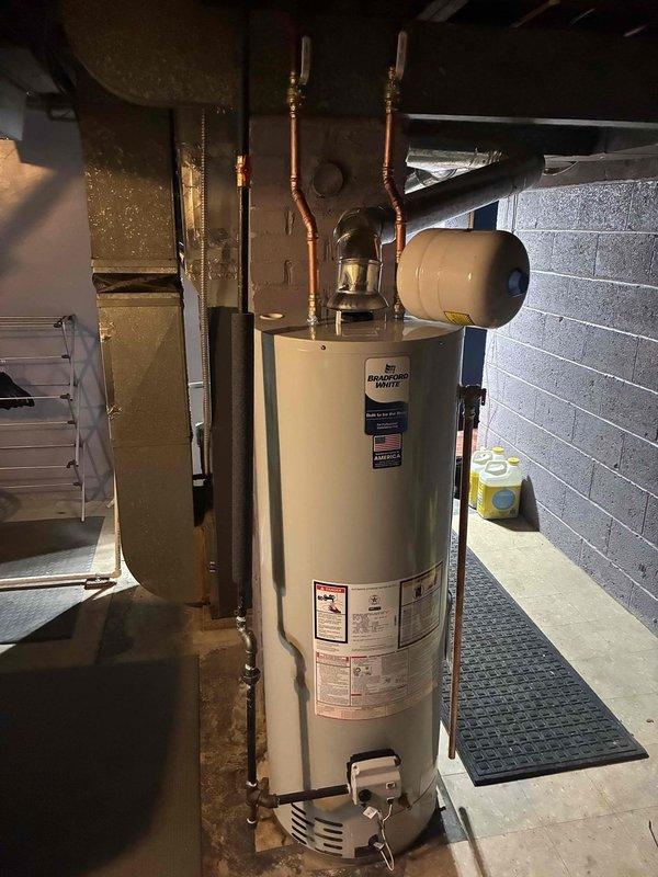 Successfully installed new 40-gallon water heater with expansion tank in basement utility room. Completed all copper pipe connections and fittings, ensuring proper valve placement for optimal operation. System is functioning correctly with no leaks observed during final testing.