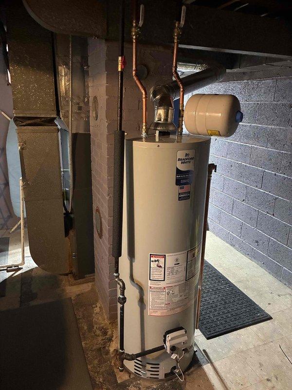 Successfully installed new 40-gallon water heater with expansion tank in basement utility room. Completed all copper pipe connections and fittings, ensuring proper valve placement for optimal operation. System is functioning correctly with no leaks observed during final testing.