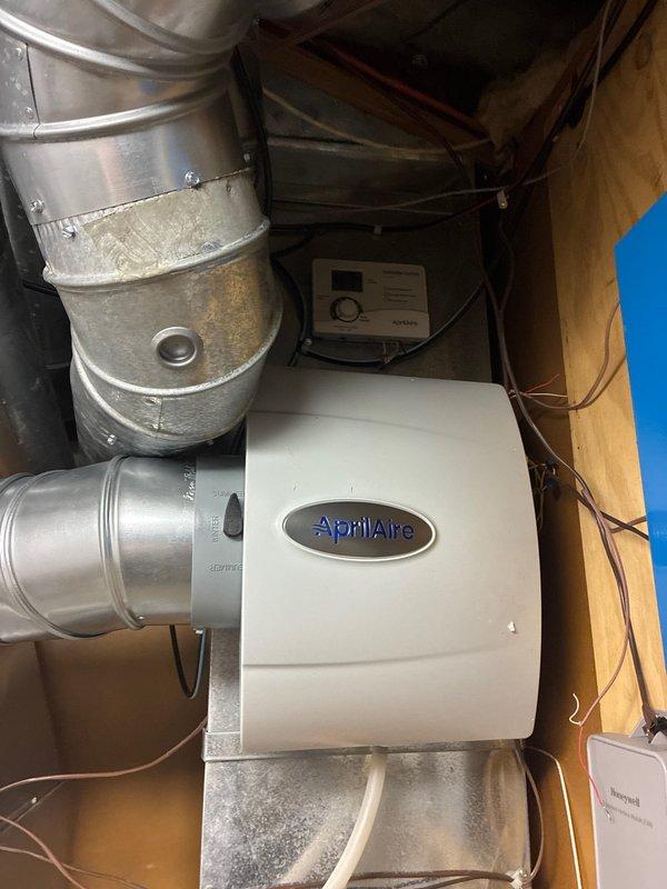 Successfully installed an Amana furnace with integrated AprilAire whole-home humidifier. System included complete ductwork connections, PVC venting, electrical wiring, and Honeywell control interface. All components were properly secured and tested for optimal performance.