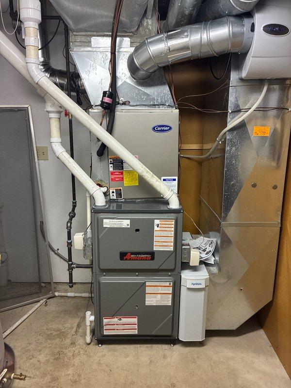 Successfully installed an Amana furnace with integrated AprilAire whole-home humidifier. System included complete ductwork connections, PVC venting, electrical wiring, and Honeywell control interface. All components were properly secured and tested for optimal performance.