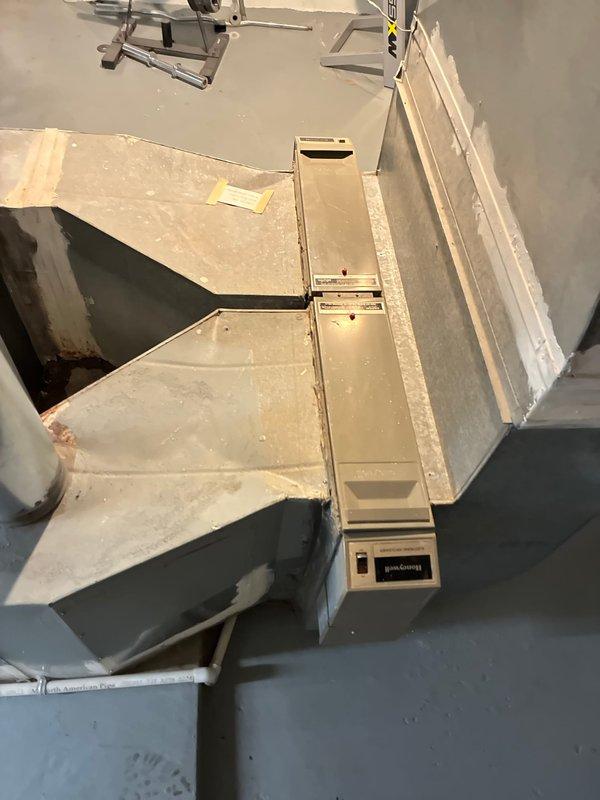 Conducted an assessment for furnace and full system replacement options, documenting the existing electrical meter configuration and current HVAC system. Evaluation included inspection of the beige air handler unit with Honeywell controls mounted against gray walls, noting the condition of ductwork connections and supporting framework for proper replacement specifications.