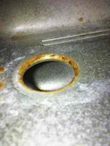 Performed scheduled heating system maintenance on aging unit. Inspection revealed significant corrosion around drainage components with visible rust deterioration on metal surfaces. Noted extensive oxidation and metal degradation on connecting pipes/ductwork, consistent with moisture exposure in a system exceeding 10 years of service.