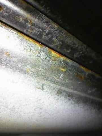 Performed scheduled heating system maintenance on aging unit. Inspection revealed significant corrosion around drainage components with visible rust deterioration on metal surfaces. Noted extensive oxidation and metal degradation on connecting pipes/ductwork, consistent with moisture exposure in a system exceeding 10 years of service.