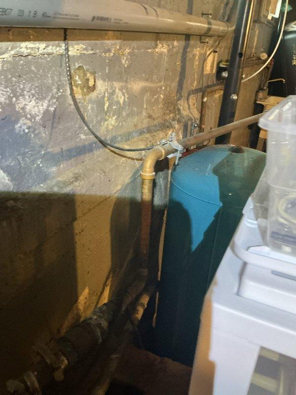 Conducted electrical inspection of residential circuit breaker panel. Documented existing panel configuration with approximately 20 breakers and noted multiple wire bundles requiring organization. Also observed nearby water damage and mineral deposits in utility area that may present potential electrical hazards.
