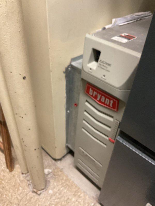 Performed routine heating maintenance on Bryant furnace system. Inspected blower motor assembly, electrical connections, and burner elements, confirming all components in working order. Documentation photos taken of exterior unit installation and interior components for service records.