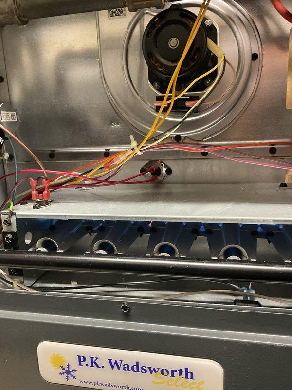 Performed routine heating maintenance on Bryant furnace system. Inspected blower motor assembly, electrical connections, and burner elements, confirming all components in working order. Documentation photos taken of exterior unit installation and interior components for service records.