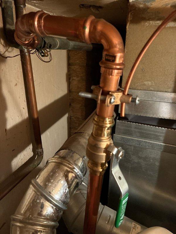 Conducted full system replacement consultation, documenting existing water heater installation and copper plumbing configuration. Evaluated current setup which includes brass valve fittings and 90-degree elbow connections for compatibility with replacement options. Photographed system components to support comprehensive replacement proposal.