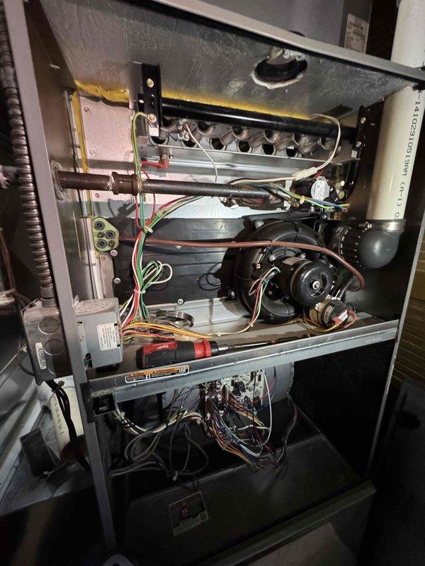 Performed routine heating maintenance on boiler system. Inspected heat exchanger, blower motor, and control board components for proper operation. Identified and documented moisture damage/discoloration at the seam where unit connects to concrete surface.