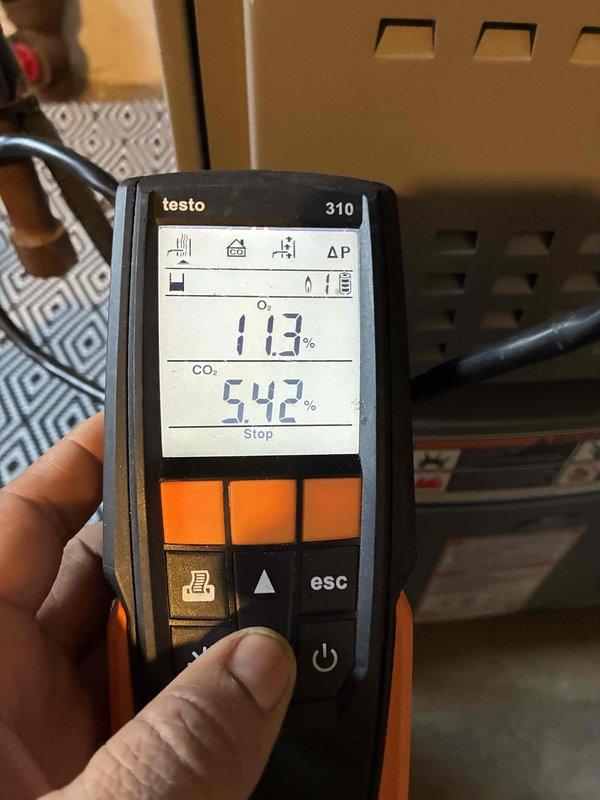 Performed routine maintenance on aging heating system. Conducted combustion analysis using Testo 310 analyzer, recording CO₂ levels at 5.42% and efficiency readings. Inspected insulation in utility area, noting some deterioration and discoloration that should be monitored.