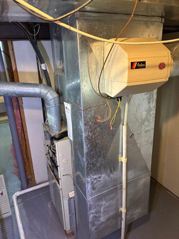 Inspected downstairs furnace system with cracked heat exchanger requiring replacement. Conducted full assessment of existing HVAC equipment including outdoor condenser unit and indoor furnace with attached humidifier. Provided replacement options to address safety concerns from compromised heat exchanger.