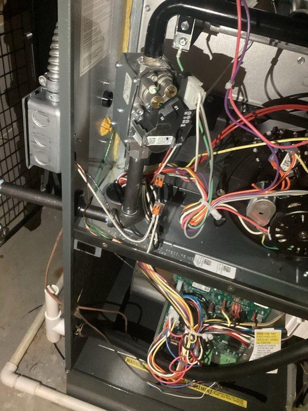 Conducted safety inspection and code compliance verification of existing electrical systems, focusing on HVAC control wiring connections and an electrical junction box installation in the framing structure. Identified and documented properly secured flexible conduit connections and appropriate wire routing through structural elements, with all components found to be functioning as designed with no safety concerns noted.