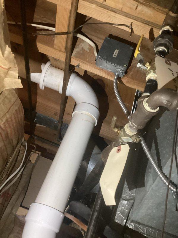 Conducted safety inspection and code compliance verification of existing electrical systems, focusing on HVAC control wiring connections and an electrical junction box installation in the framing structure. Identified and documented properly secured flexible conduit connections and appropriate wire routing through structural elements, with all components found to be functioning as designed with no safety concerns noted.