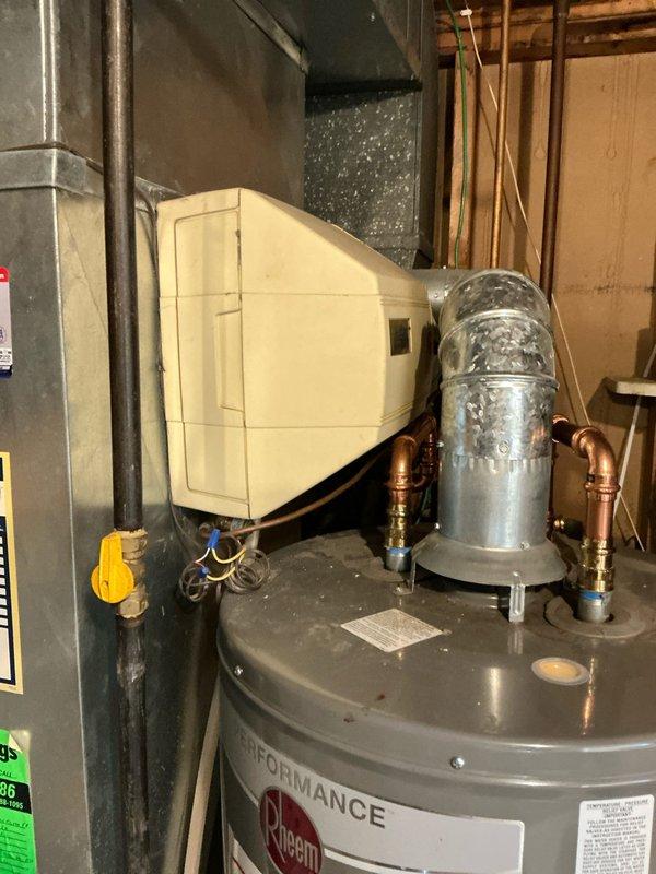 Conducted comprehensive inspection of existing HVAC system and water heater in residential basement mechanical room. Evaluated current setup which includes a Rheem Performance water heater with copper piping, connected humidifier unit, and furnace with associated ductwork. Presented full system replacement options based on assessment findings.