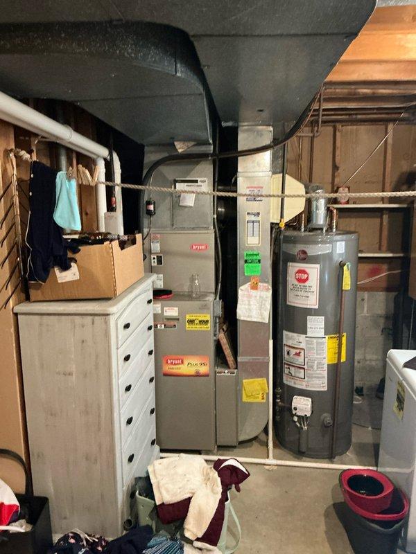 Conducted comprehensive inspection of existing HVAC system and water heater in residential basement mechanical room. Evaluated current setup which includes a Rheem Performance water heater with copper piping, connected humidifier unit, and furnace with associated ductwork. Presented full system replacement options based on assessment findings.