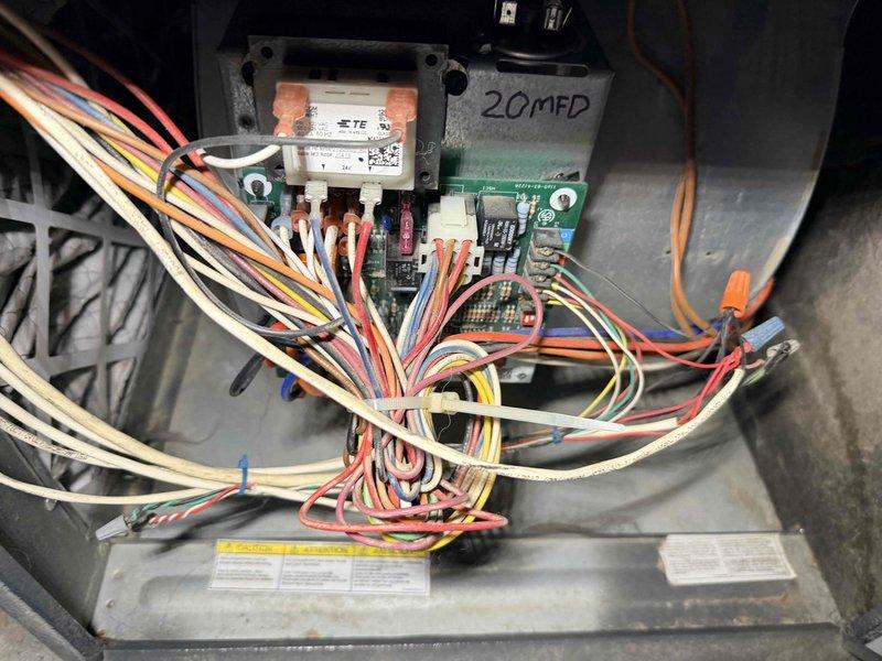 Performed heating system maintenance and identified significant frost accumulation on the evaporator coil/refrigerant lines. Inspected electrical components including circuit board connections and verified proper operation of the 20MFD capacitor. System was restored to normal operating parameters with all connections secure.
