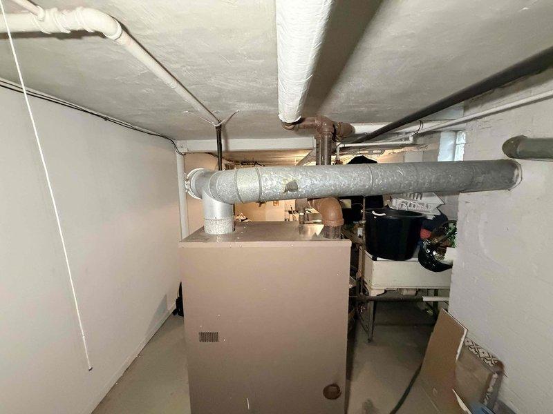 Performed routine maintenance on basement boiler system, including inspection of water heater, expansion tank, and associated copper piping network. Checked all valves for proper operation and examined ductwork integrity throughout the utility area. Documentation of equipment specifications completed for service records.