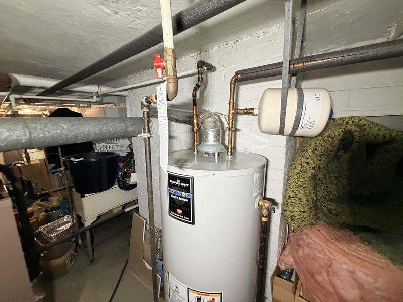 Performed routine maintenance on basement boiler system, including inspection of water heater, expansion tank, and associated copper piping network. Checked all valves for proper operation and examined ductwork integrity throughout the utility area. Documentation of equipment specifications completed for service records.