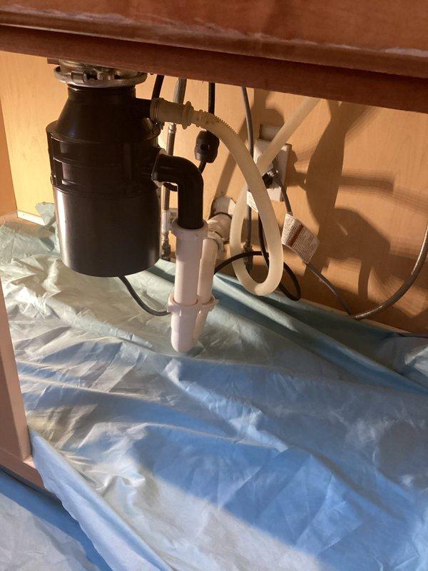 Successfully completed garbage disposal replacement service. Installed new black disposal unit with proper connections to existing white PVC drain system. Verified installation with no leaks and confirmed proper operation after service completion.