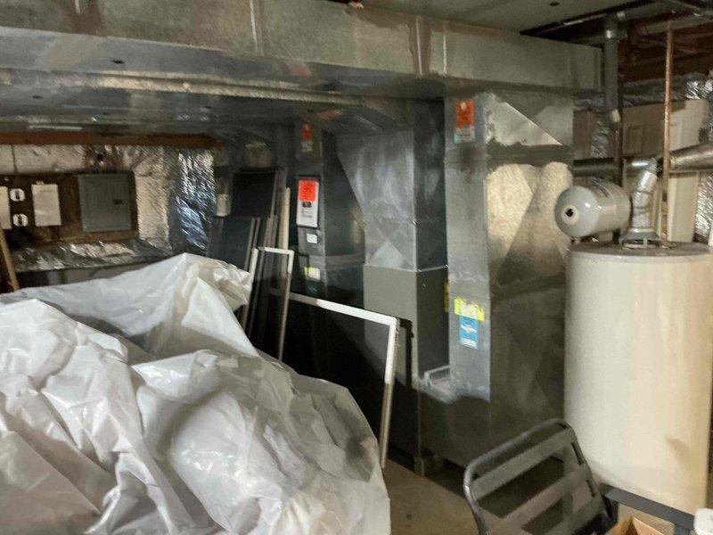 Conducted comprehensive assessment of existing HVAC system in basement utility room, documenting current furnace condition and surrounding installation environment. Presented customer with multiple furnace replacement options based on evaluation of existing unit, ductwork configuration, and available space constraints. Photos captured for documentation show current furnace setup alongside water heater with appropriate clearances and potential installation considerations.