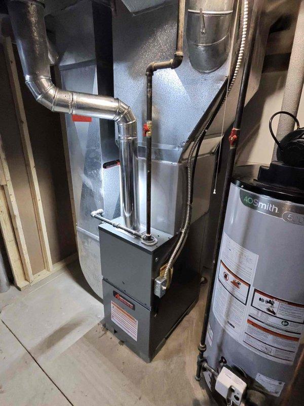 Successfully installed 80% efficiency furnace in utility room with proper ductwork connections and exhaust venting. Completed combustion analysis with readings of O2 at 13.6%, CO at 5ppm, CO2 at 4.2%, and stack temperature of 273.2°F, confirming proper operation within manufacturer specifications.