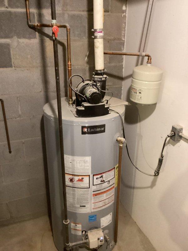 Conducted comprehensive inspection of residential water heating system, including Lochinmar water heater unit, circulator pump, expansion tank, and associated copper piping network. Documented condition of all components with photographic evidence, noting proper installation of electrical connections and no visible signs of damage or deterioration to the system.
