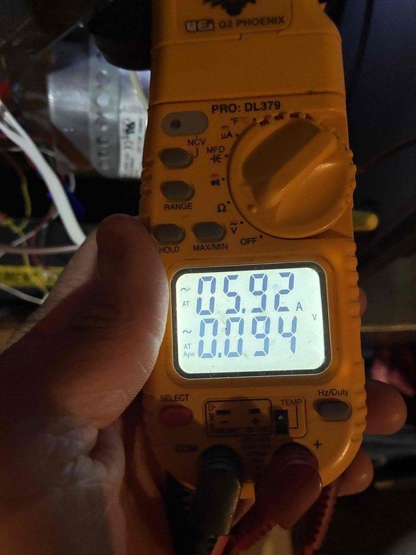 Completed routine heating system maintenance including electrical testing with multimeter showing normal voltage readings (0.592V/0.094A). Inspected blower motor assembly and verified proper electrical connections to fan housing, with all wiring (including ground wire) secure and in good condition. System operating within normal parameters with no issues detected.