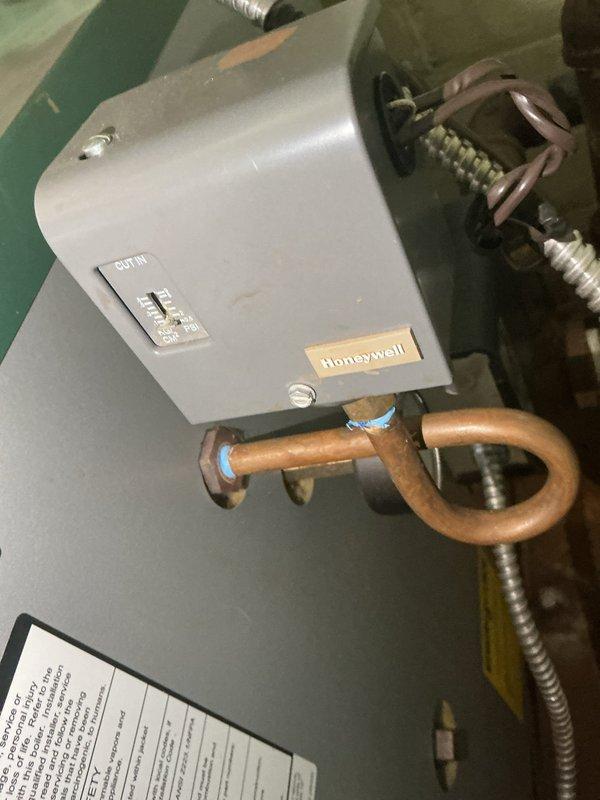 Performed routine heating maintenance service on system. Inspected Honeywell control device and verified proper operation of cut-in switch. System pressure gauge reading at 17-18 PSI, within normal operating parameters for this heating unit.