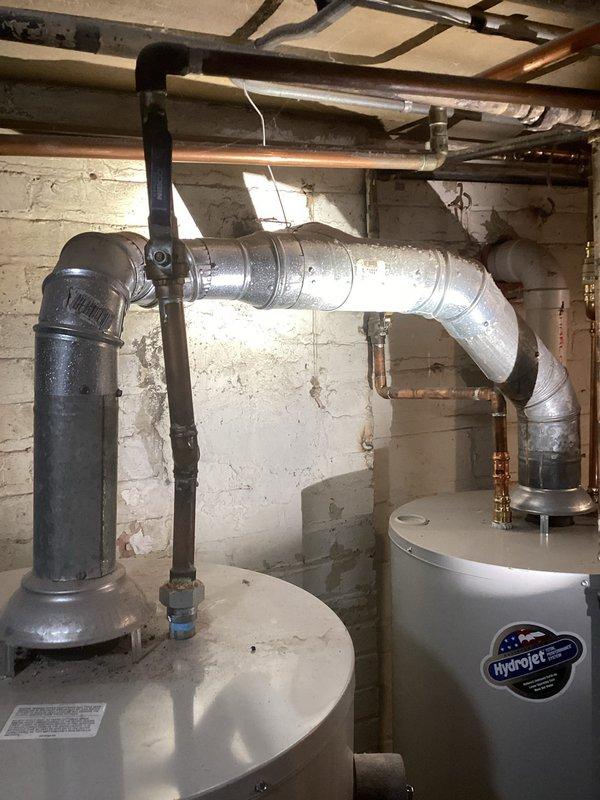 Conducted plumbing inspection identifying significant water damage and ceiling deterioration with potential mold growth in an upstairs room. Traced source to the basement utility area where two water heaters (including a Hydrojet unit) and associated copper and metal piping were examined, though no active leaks were detected in the plumbing system at time of inspection.
