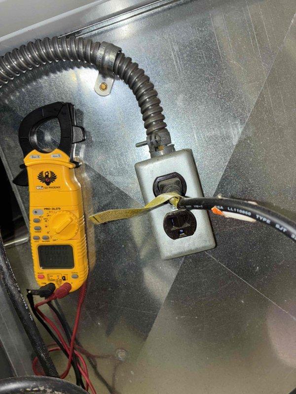 Completed routine heating maintenance service. Performed electrical testing with clamp meter on outlet connection and inspected mounting bracket assembly securing cylindrical component with associated wiring. System functioning properly with no issues identified.