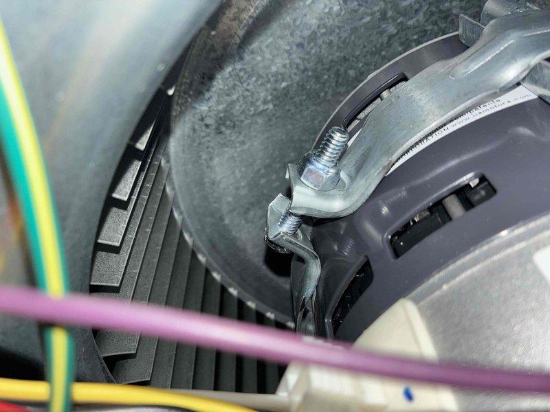 Completed routine heating maintenance service. Performed electrical testing with clamp meter on outlet connection and inspected mounting bracket assembly securing cylindrical component with associated wiring. System functioning properly with no issues identified.