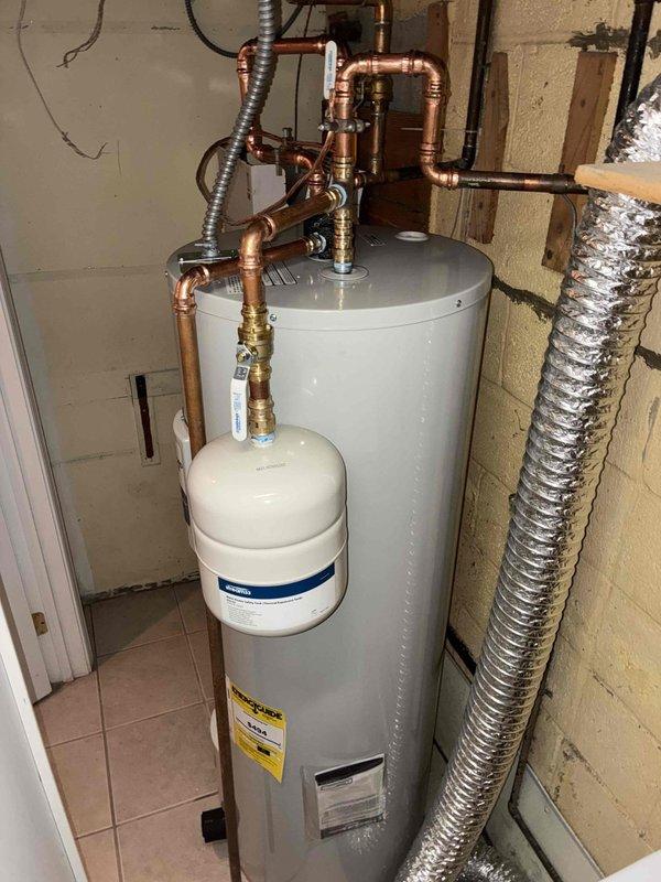 Successfully installed a 50-gallon Bradford White electric water heater with accompanying expansion tank in utility area. Completed all necessary copper piping connections with appropriate brass fittings and valves to integrate with existing plumbing system. System was tested and confirmed to be functioning properly with no leaks.