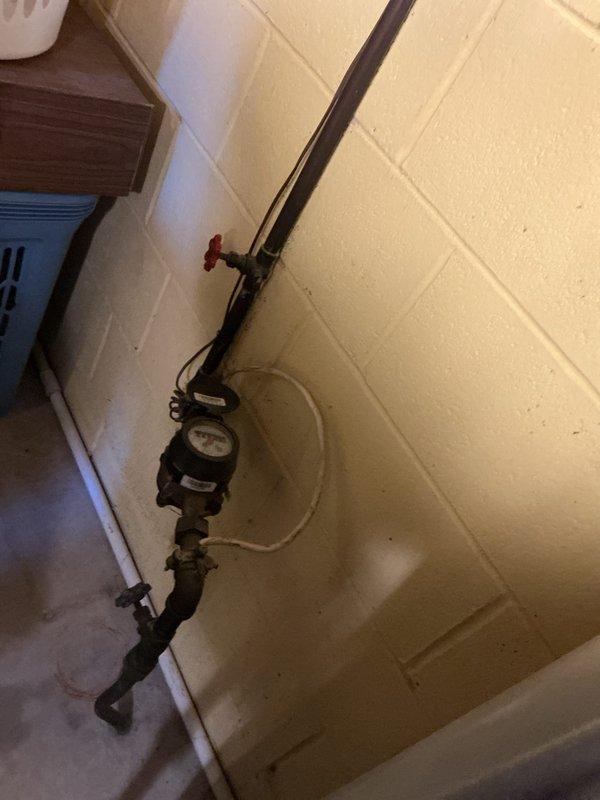 Completed 8-point electrical inspection. Verified plumbing installation with pressure gauge and valve system in utility area. Examined kitchen electrical outlet with small appliance connection and inspected backsplash area for any electrical hazards. Documented findings with photos.
