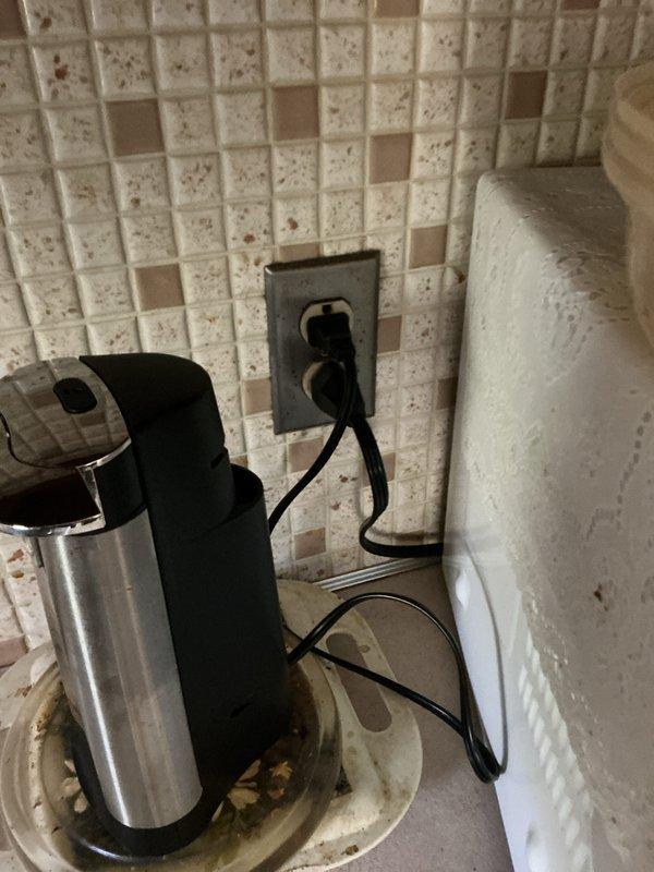 Completed 8-point electrical inspection. Verified plumbing installation with pressure gauge and valve system in utility area. Examined kitchen electrical outlet with small appliance connection and inspected backsplash area for any electrical hazards. Documented findings with photos.