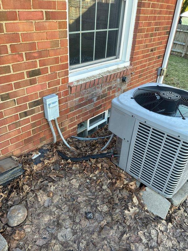 Conducted site assessment at residential property to provide furnace replacement options due to high repair costs on existing unit. Inspected exterior HVAC condenser unit and electrical connections, noting accumulated debris around the unit. Verified electrical service via the Centron digital meter to ensure proper power supply for potential replacement equipment.
