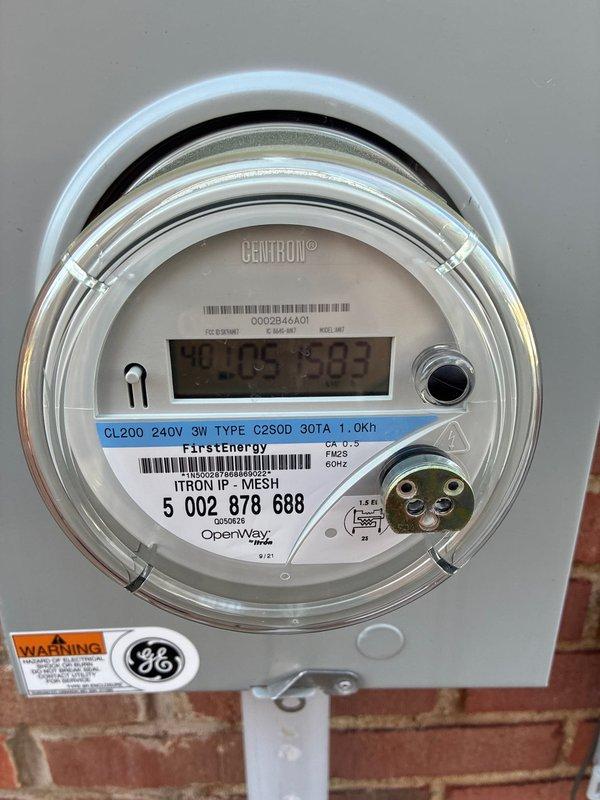 Conducted site assessment at residential property to provide furnace replacement options due to high repair costs on existing unit. Inspected exterior HVAC condenser unit and electrical connections, noting accumulated debris around the unit. Verified electrical service via the Centron digital meter to ensure proper power supply for potential replacement equipment.