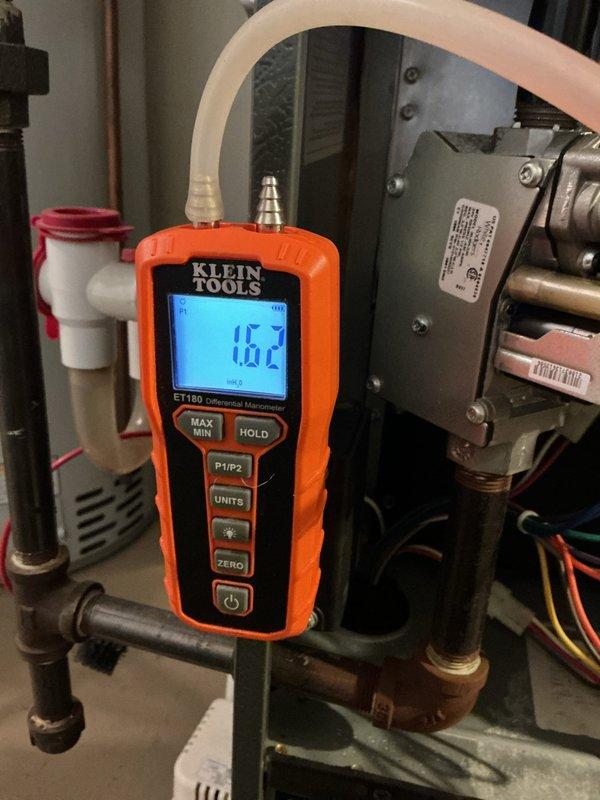 Performed scheduled heating maintenance on P.R. Wadsworth furnace system. Conducted pressure testing with manometer showing 0.62" reading on gas supply, confirming proper operation. Inspected ventilation system including PVC exhaust components; all connections secure with no issues detected.